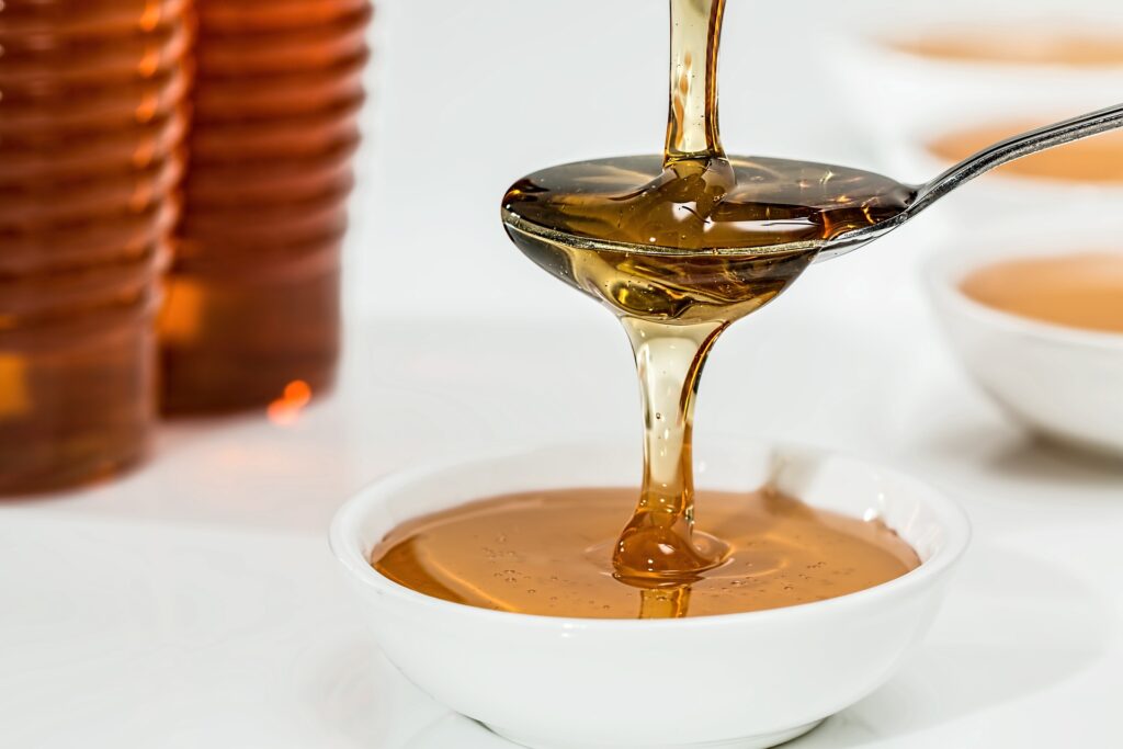 Honey in a bowl and a teaspoon of honey