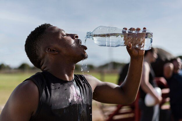 Man drinking water to hydrate himself 