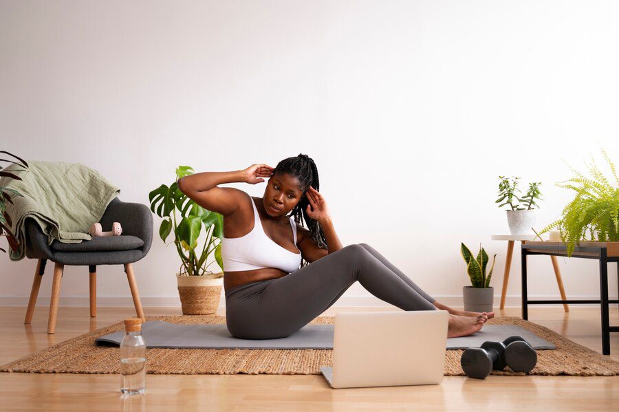 A woman exercising in her home as a way she is managing stress