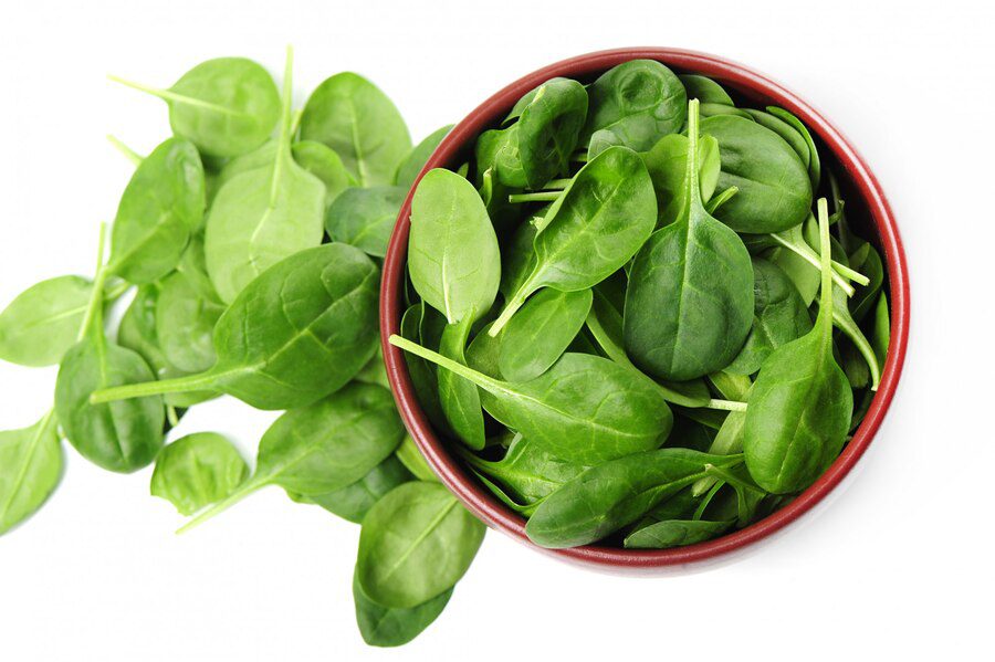 a bowl of leafy greens which are also a part of healthy foods.