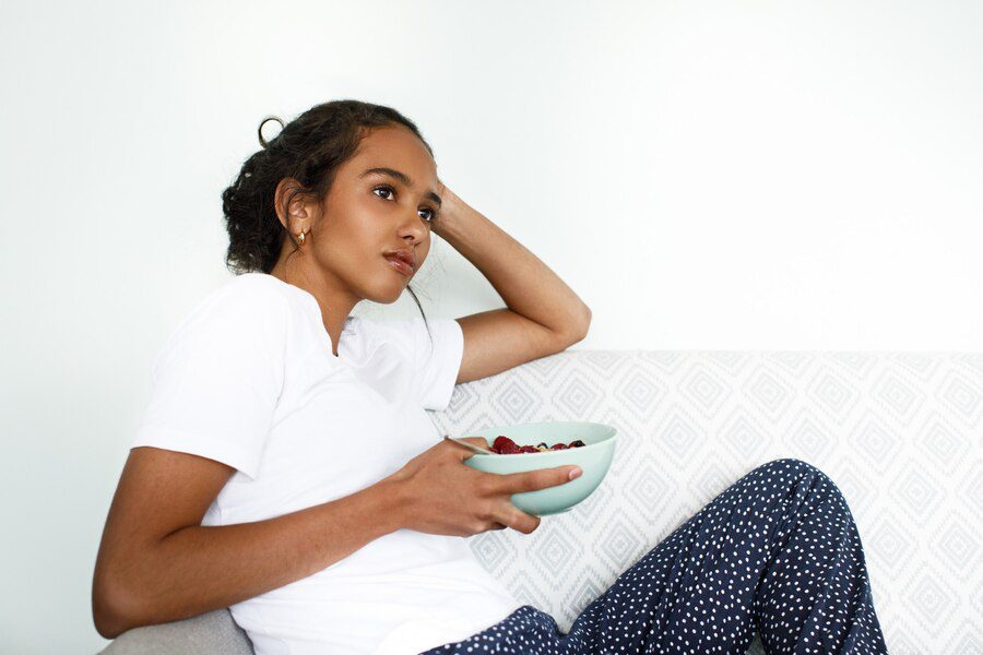 A lady in her home wondering whether to skip breakfast 